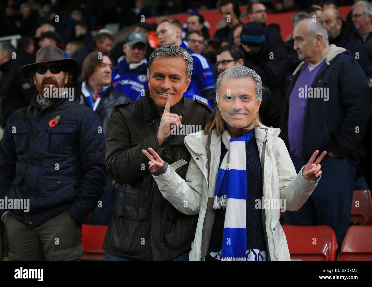 Chelsea fans wearing masks of manager Jose Mourinho in the stands during the Barclays Premier League match at the Britannia Stadium, Stoke-on-Trent. Stock Photo
