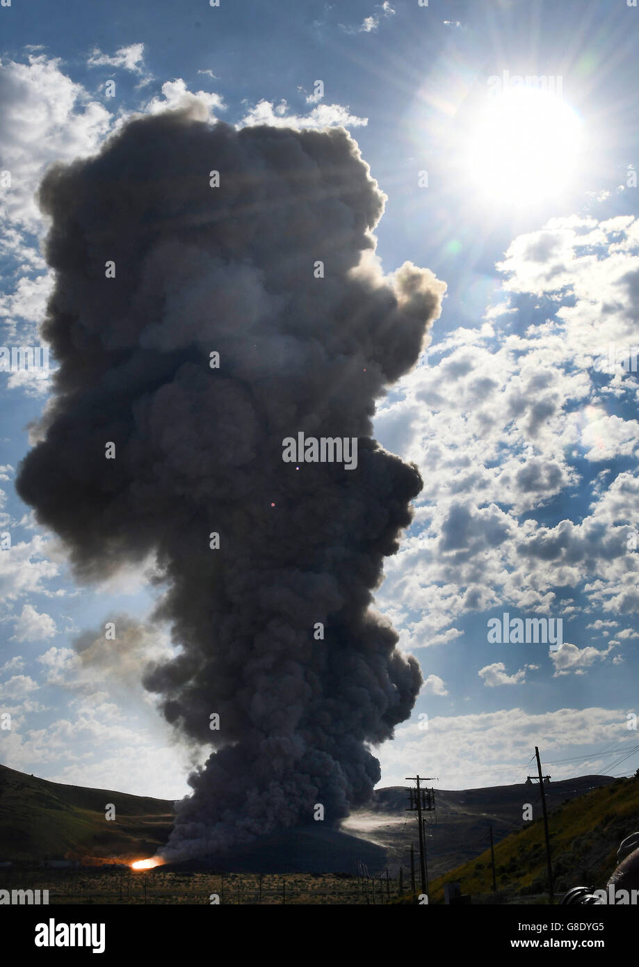 June 28, 2016. Promontory UT. Raw fire power is blasted into a hillside as ATK test fires a solid rocket booster motor that burns 6 tons of propellant each second with expanding gases and flames exiting the nozzle at speeds in excess of Mach 3 and temperatures reaching 3,700 degrees Fahrenheit Tuesday. Orbital ATK test fire happen at 9:05am MT time and NASA will use measurements from more than 530 data channels to evaluate motor performance, acoustics, motor vibrations, nozzle modifications, insulation upgrades. Photo by Gene Blevins/LA DailyNews/ZumaPress. (Credit Image: © Gene Blevins via Stock Photo