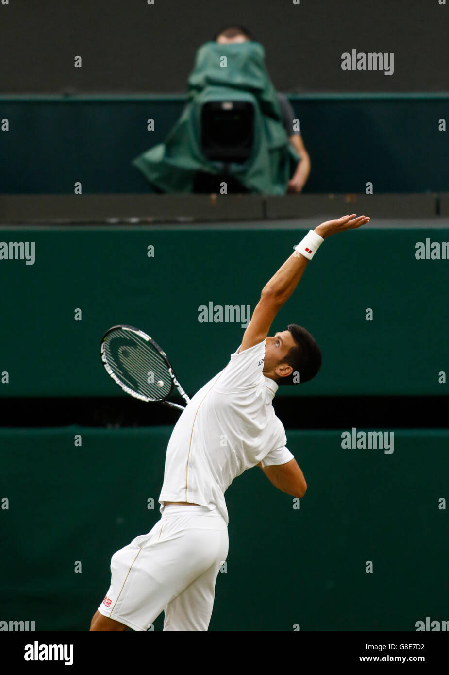 29.06.2016. All England Lawn Tennis and Croquet Club, London, England. The Wimbledon Tennis Championships Day Three. Number 1 seed, Novak Djokovic (SER) serves under the watchful gaze of the TV camera during his singles match against Adrian Mannarino (FRA). Stock Photo