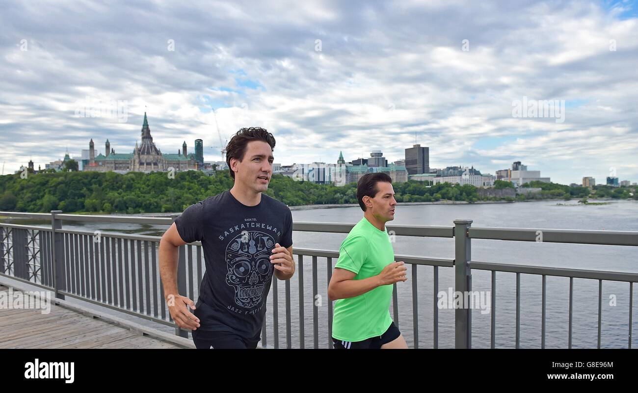 Ottawa, Canada. 29th June, 2016. Canadian Prime Minister Justin Trudeau, left, and Mexican President Enrique Pena Nieto go for a morning run across the Alexandra Bridge from Ottawa to Gatineau with Parliament Hill in the background June 28, 2016 in Ottawa, Canada. Credit:  Planetpix/Alamy Live News Stock Photo
