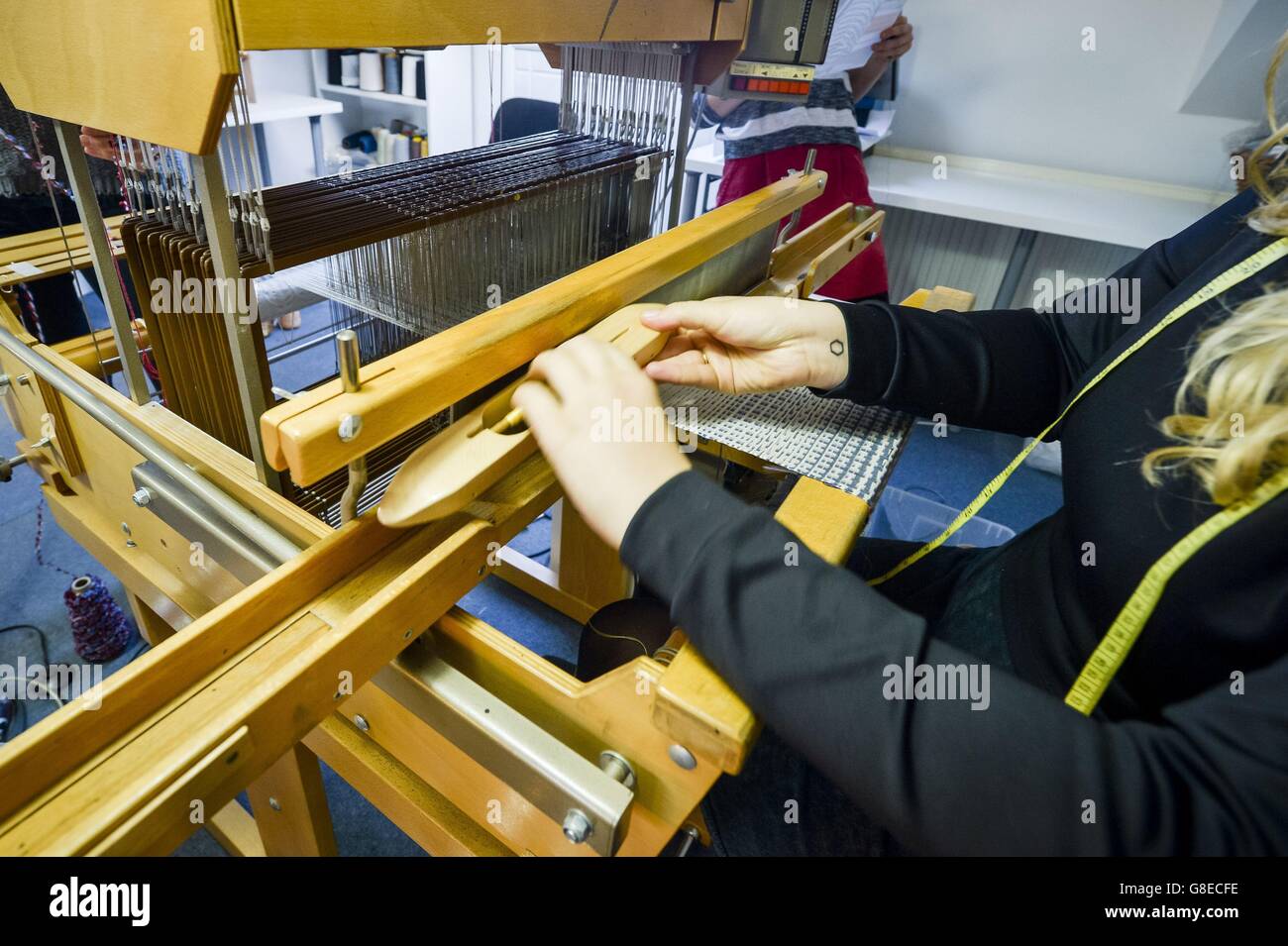 s first all-female weaving mill using traditional style wooden weaving looms at The Bristol Weaving Mill, the first working cloth mill in Bristol in nearly 100 years. Stock Photo