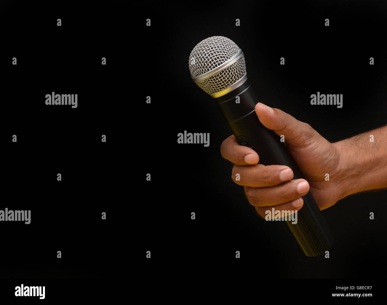 Professional holding microphone in hand while giving motivational speech. Stock Photo