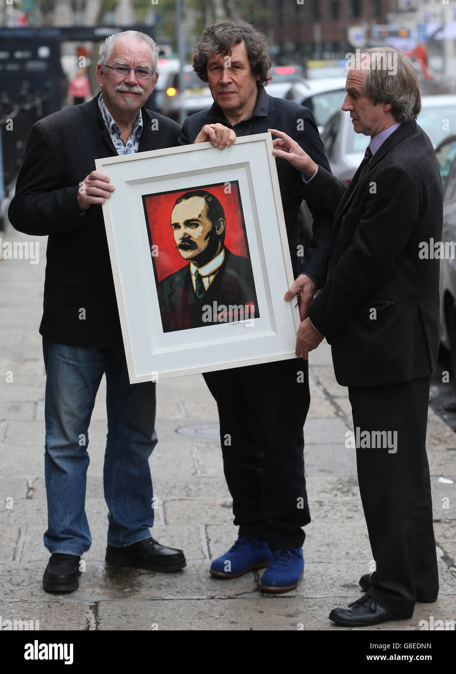Artist Robert Ballagh (left) presents one of Ireland's most celebrated actors, Stephen Rea (centre), with a limited edition print of Jim Fitzpatrick's image of James Connolly, specially created for Reclaim the Vision of 1916 event in Dublin this afternoon. Looking on is James Connolly's great-grandson James Connelly Heron (right). Stock Photo
