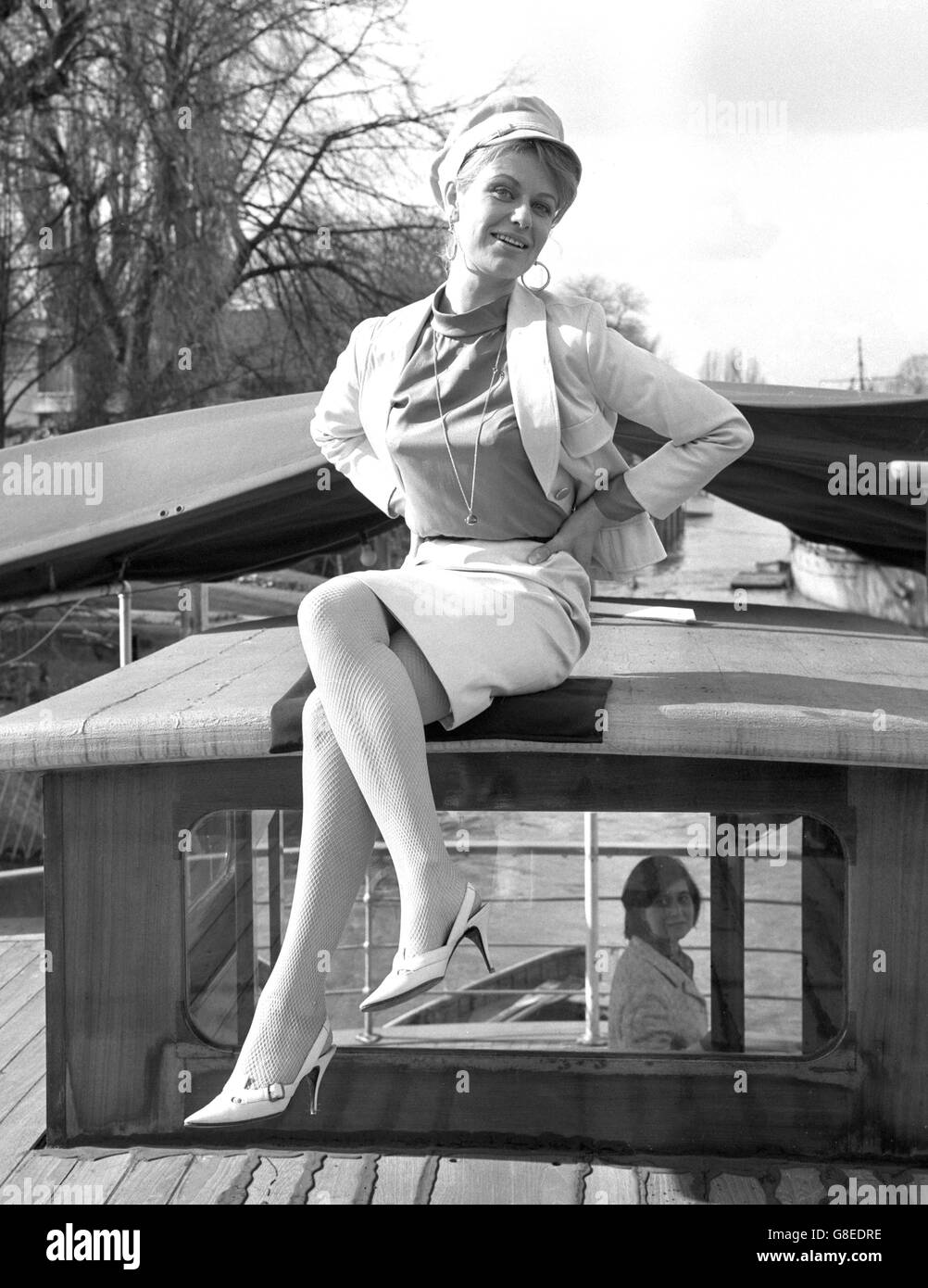Actress Sally Bazely wears a beige-coloured 'coster' hat and matching outfit aboard ABC Television's houseboat MV Iris at Teddington Lock. She was at a buffet luncheon to introduce stars, authors and productions chiefs of the seven-play season of comedies to be presented by Armchair Theatre. miss Bazely will be seen in the first of the series 'Man Without a Mortgage' by Donald Churchill. Stock Photo