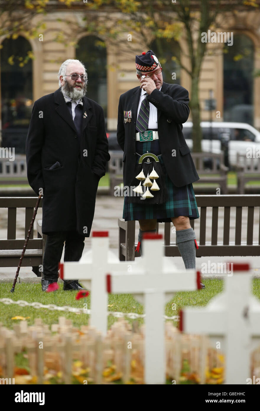 James McEwan (right), who served with the Argyll and Sutherland Highlanders, sheds a tear as he looks at the garden of remembrance in George Square, Glasgow, alongside Peter Ferguson, who lost his son in the Iraq conflict. Stock Photo