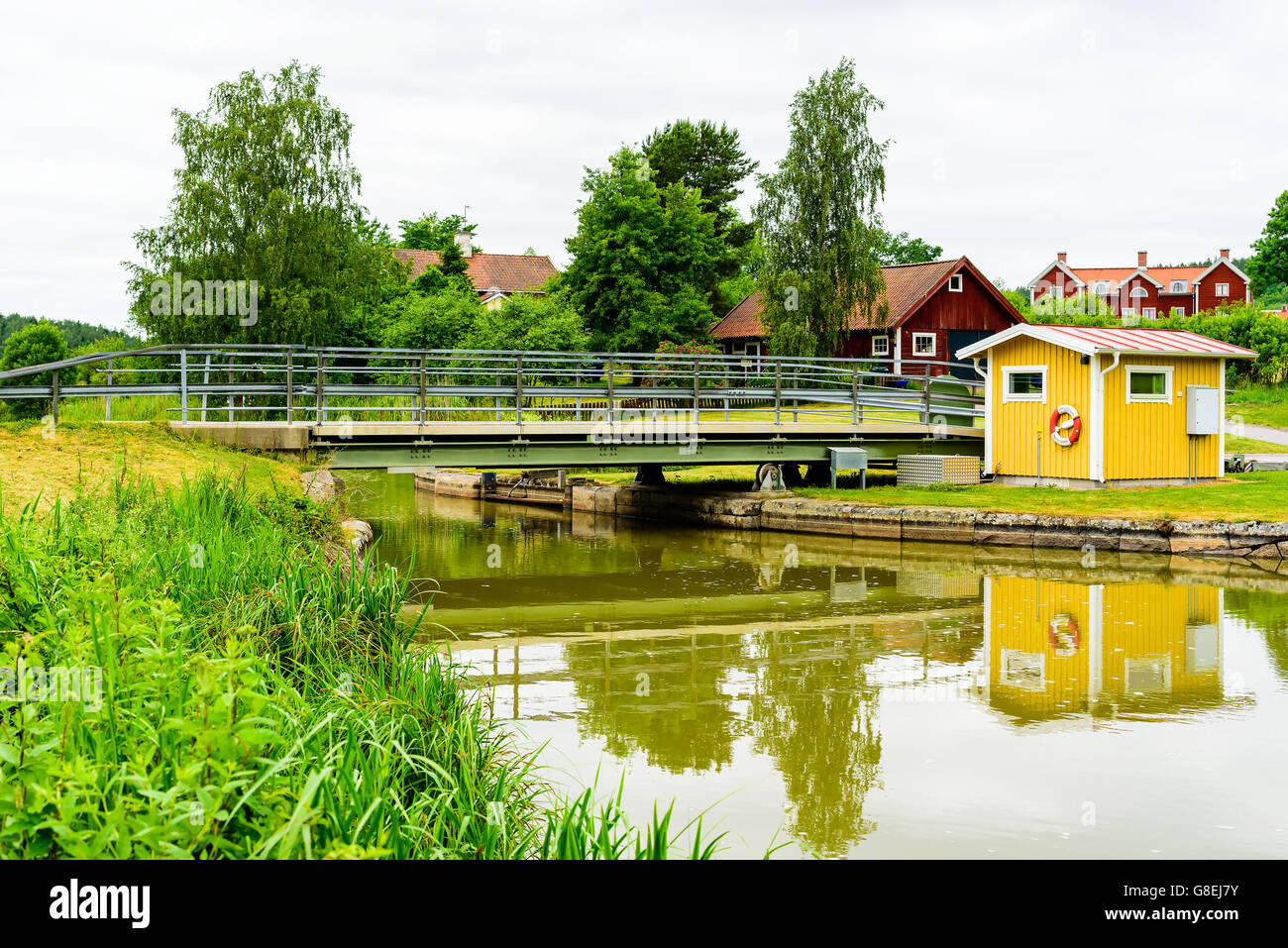 Venneberga, Sweden - June 20, 2016: Retractable rolling iron bridge over a canal. Bridge is retractable by wheels and rolls to t Stock Photo