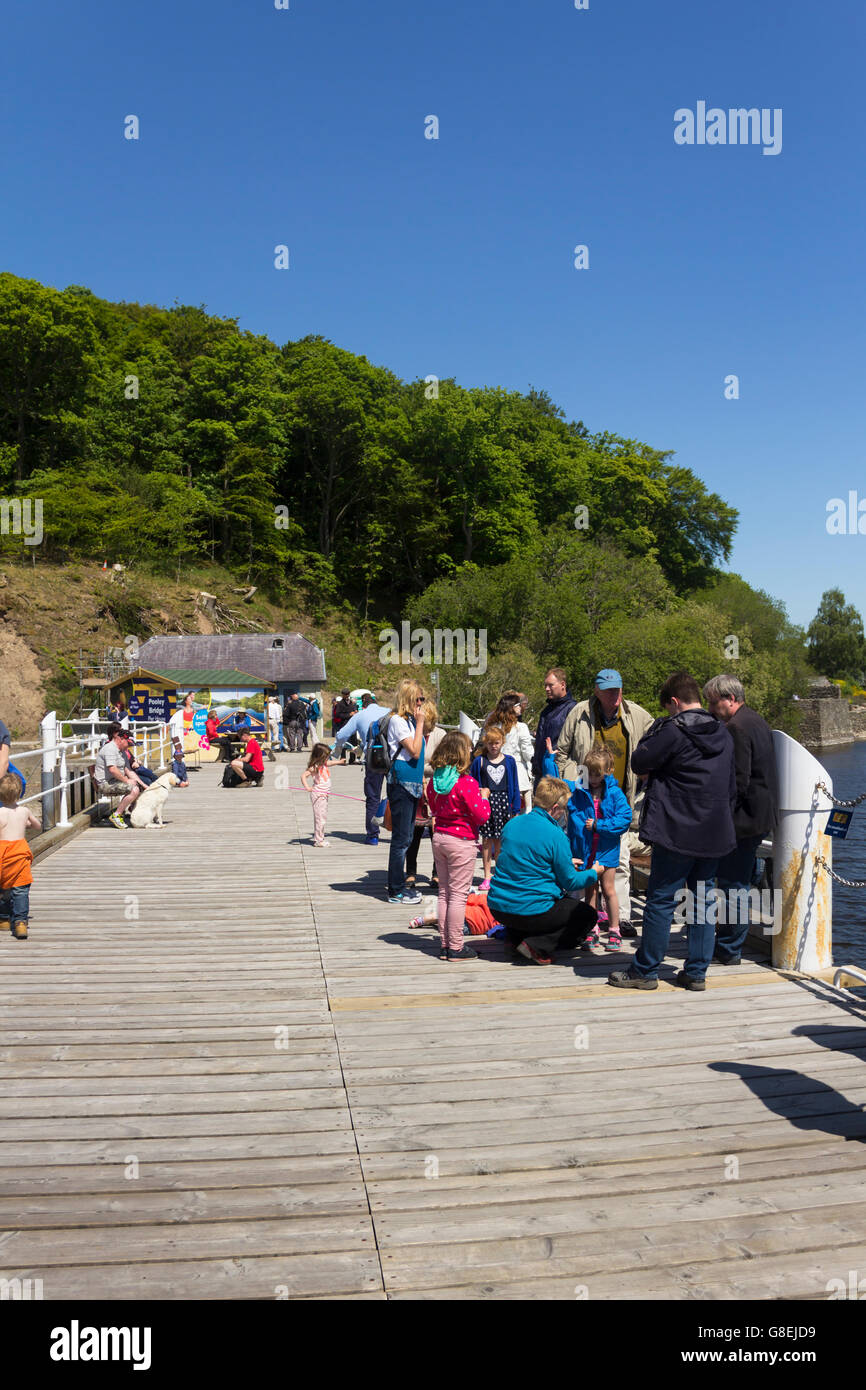 Passengers gather on Ullswater Steamers Pooley Bridge pier, Cumbria, ready for the 13:55 sailing to Glenridding. Stock Photo