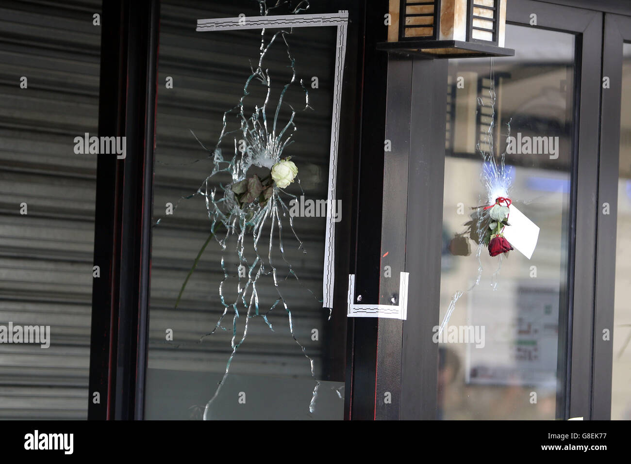 Floral tributes on the windows of La Belle Equipe bar in Paris, after terror attacks killed at least 129 people in the city on Friday. Stock Photo