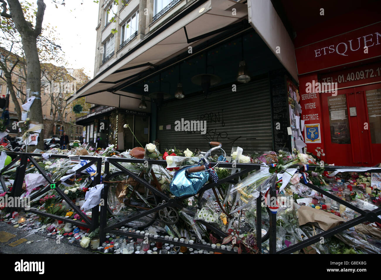 Floral tributes and candles outside the La Belle Equipe bar in Paris, after terror attacks killed at least 129 people in the city on Friday. Stock Photo