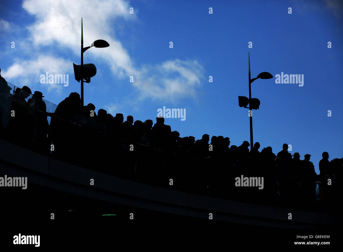 Racegoers on the Crescent Walkway during day one of The Open meeting, at Cheltenham Racecourse. Stock Photo