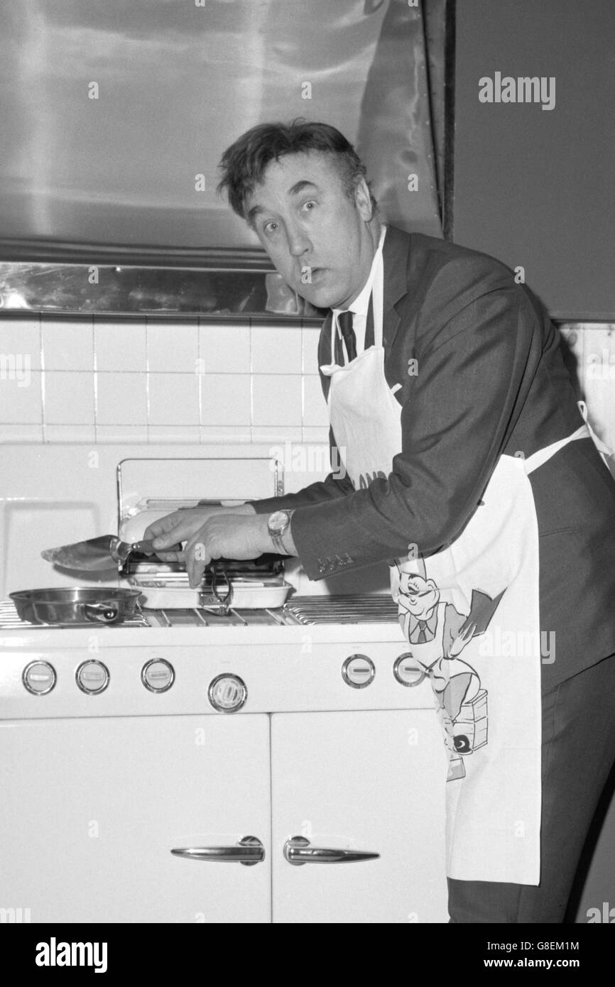 Comedian Frankie Howerd knocks up an omelette after officially turning on the gas in the 'Super Calor Kitchen', in a demonstration at the Dorchester Hotel, London. On show were the latest cookers, water heaters, refrigerators, fires and other appliances from leading manufacturers. Stock Photo