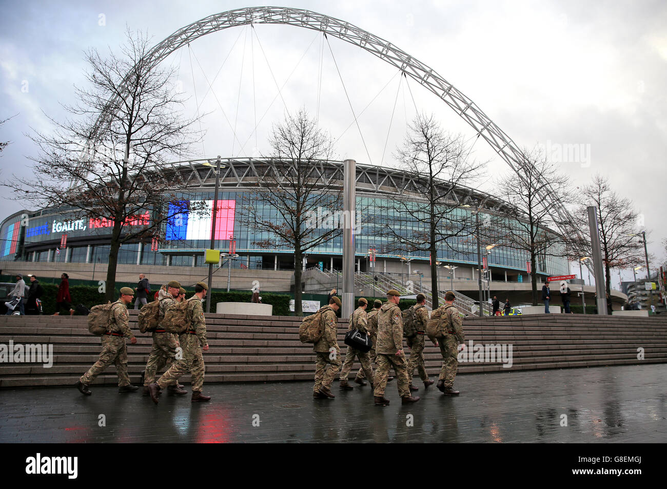 Members of the armed forces walking past the ground before the international friendly match at Wembley Stadium, London. Stock Photo