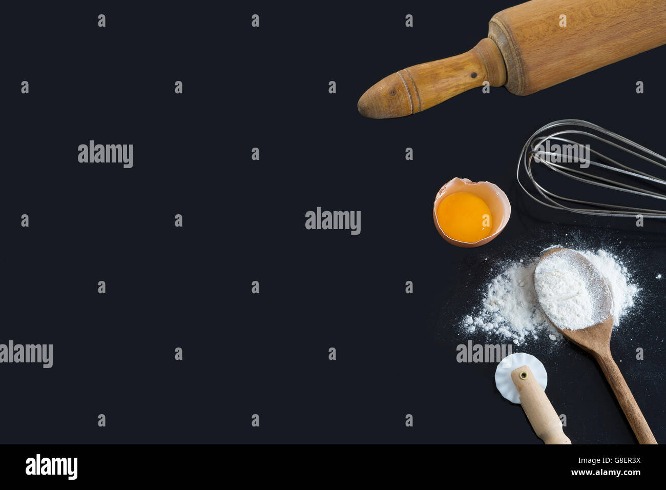 whisk and ingredients on a black background Stock Photo Alamy