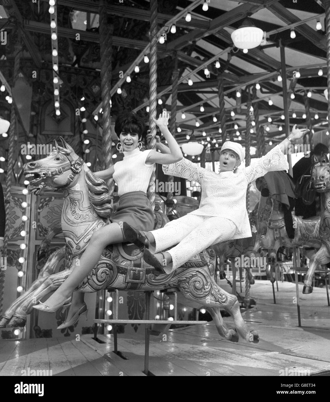 Jan Butlin (right) and Sandra Barry on a merry-go-round, when they tried out some of the rides and sideshows at Battersea Festival Gardens and Fun Fair, London. Stock Photo
