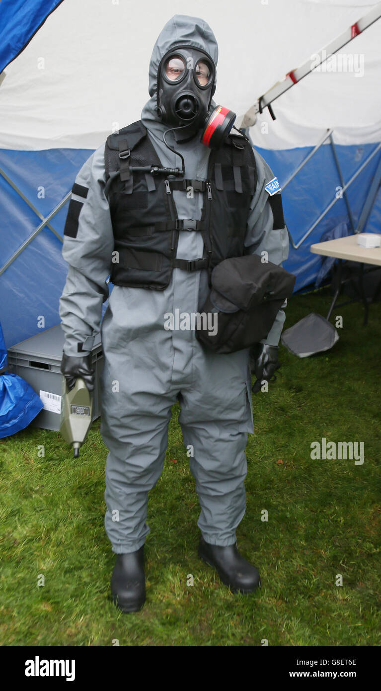 A PSNI officer poses for pictures in a Chemical, Biological, Radiological and Nuclear (CBRN) Protection Suit holding a chemical agent detector, as Northern Irelands emergency services take part in a major review of civil contingency arrangements and put on display the equipment used to deal with crisis and disaster at the Thiepval Barracks in Lisburn. Stock Photo