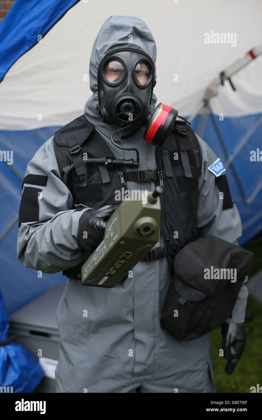 A PSNI officer poses for pictures in a Chemical, Biological, Radiological and Nuclear (CBRN) Protection Suit holding a chemical agent detector, as Northern Irelands emergency services take part in a major review of civil contingency arrangements and put on display the equipment used to deal with crisis and disaster at the Thiepval Barracks in Lisburn. Stock Photo