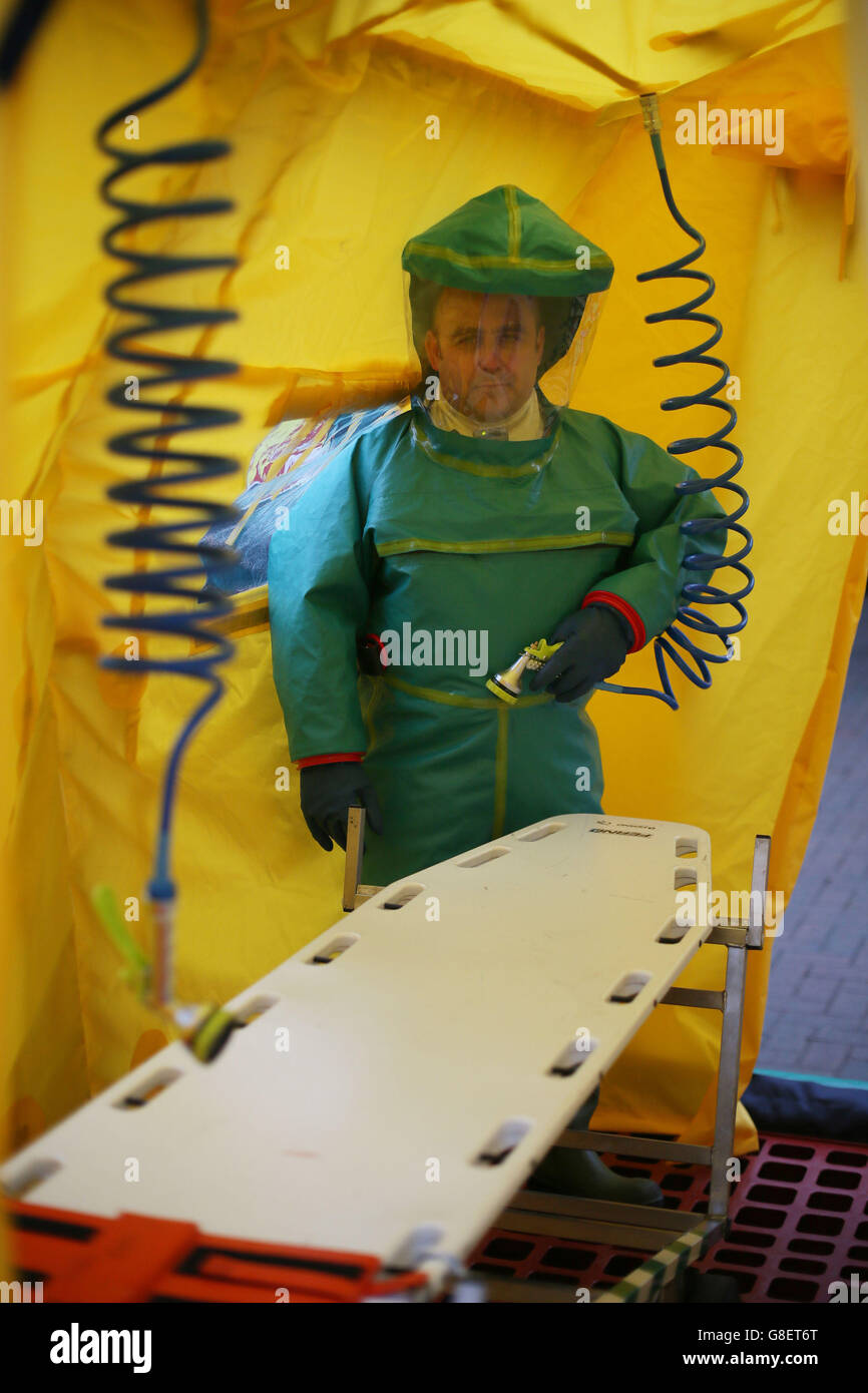 A member of the Ambulance Service wears a Powered Respirator Protective Suit (PRPS) inside a decontamination tent, as Northern Irelands emergency services take part in a major review of civil contingency arrangements and put on display the equipment used to deal with crisis and disaster at the Thiepval Barracks in Lisburn. Stock Photo