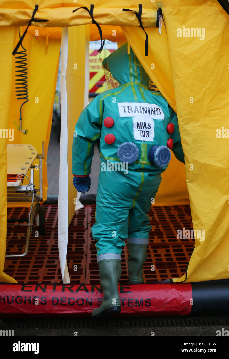 A member of the Ambulance Service enters a decontamination tent wearing a Powered Respirator Protective Suit (PRPS), as Northern Irelands emergency services take part in a major review of civil contingency arrangements and put on display the equipment used to deal with crisis and disaster at the Thiepval Barracks in Lisburn. Stock Photo