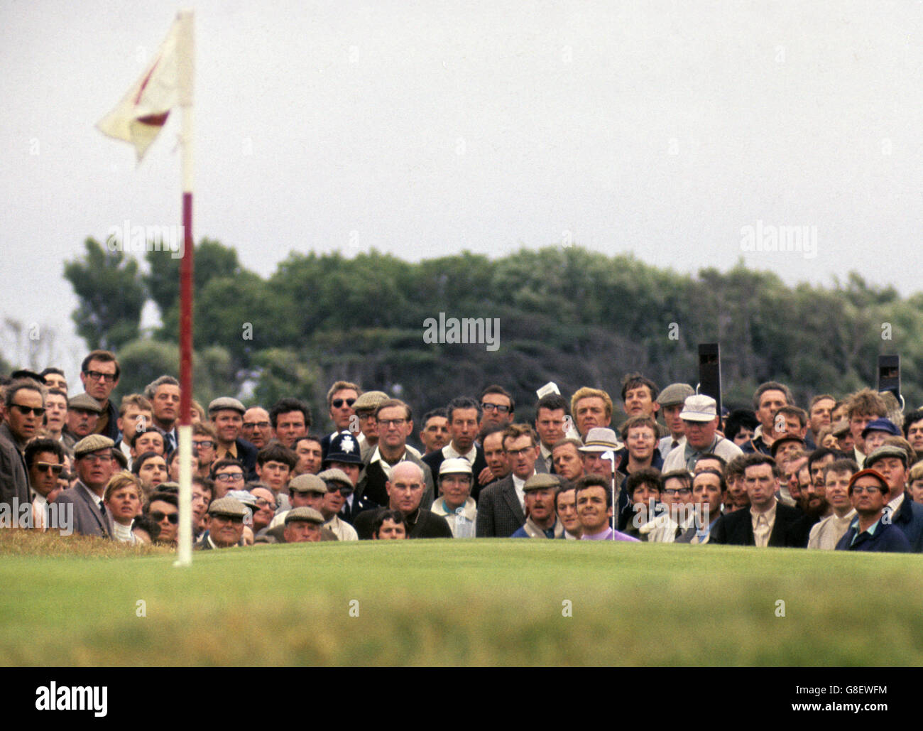 Englishman Tony Jacklin, with a gallery behind him, comes up on a green during the 1969 Open Championship at Royal Lytham and St Annes Golf Club, which he would go on to win. Stock Photo