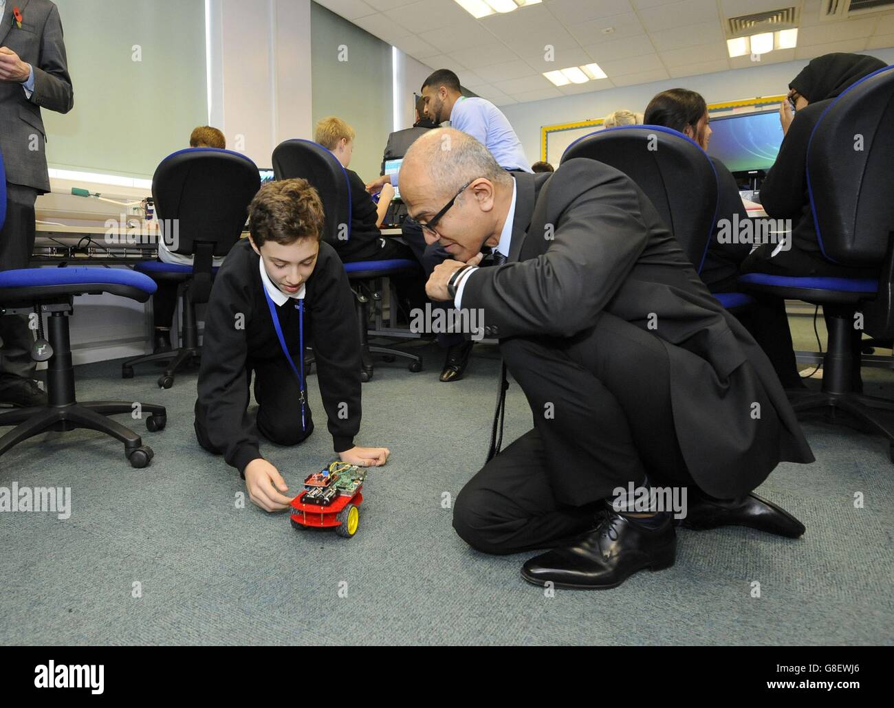 Mihnea (surname not given), 11, shows Microsoft chief executive Satya Nadella his creation using a micro:bit during a visit to Eastlea Community School in Newham, east London, where children have been trialling the micro:bit ahead of them being distributed to other children by the BBC next year. Stock Photo