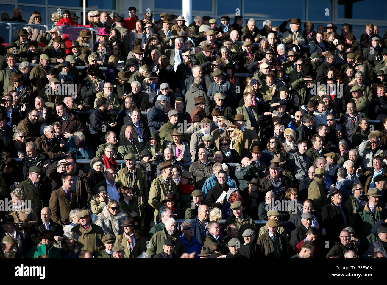 Racegoers watch from The Princess Royal Grandstand during day one of The Open meeting, at Cheltenham Racecourse. Stock Photo
