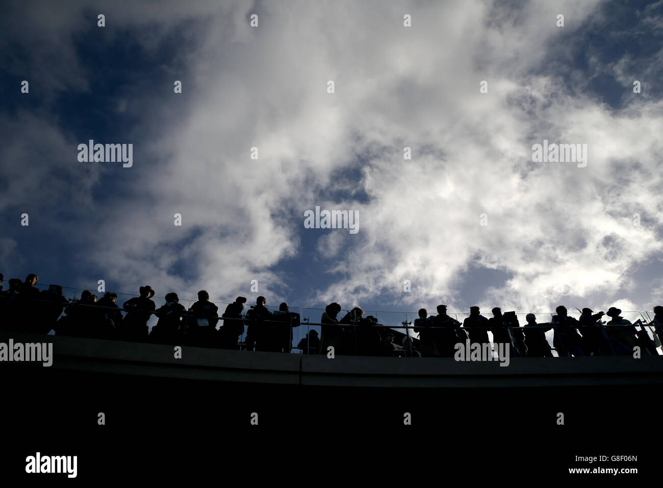 Racegoers on the Crescent Walkway during day one of The Open meeting, at Cheltenham Racecourse. Stock Photo