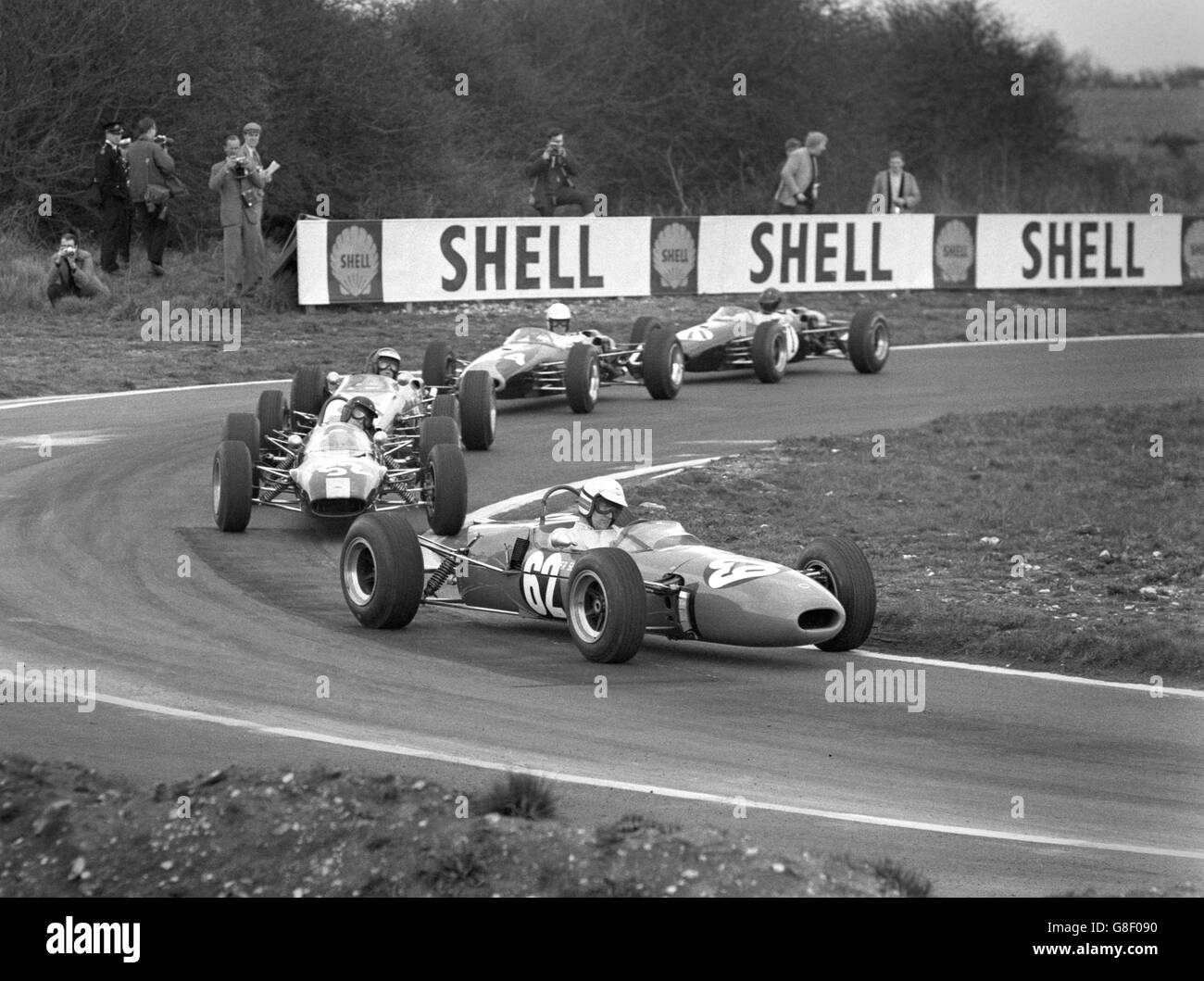 Single-seater racing cars in the Formula 3 event at the Snetterton Good Friday meeting. They are coming around Russell Corner. In front is BR Hart in the Lotus Ford, who came third, followed by the eventual winner Roy Pike. He won the 15-lap race in 26 minutes, 53.8 seconds, at an average speed of 90.68mph. Stock Photo