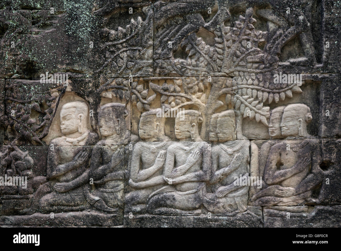 Mahayana Buddhist carvings showing arhats / boddhisattvas - on the side of the 12th or 13th Century Bayon temple, Angkor Thom, Cambodia Stock Photo
