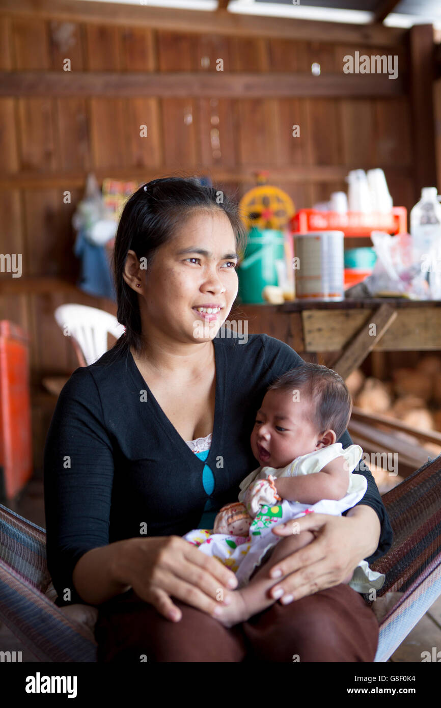 Villager with a baby in a fishing village on Koh Rong Stock Photo Alamy