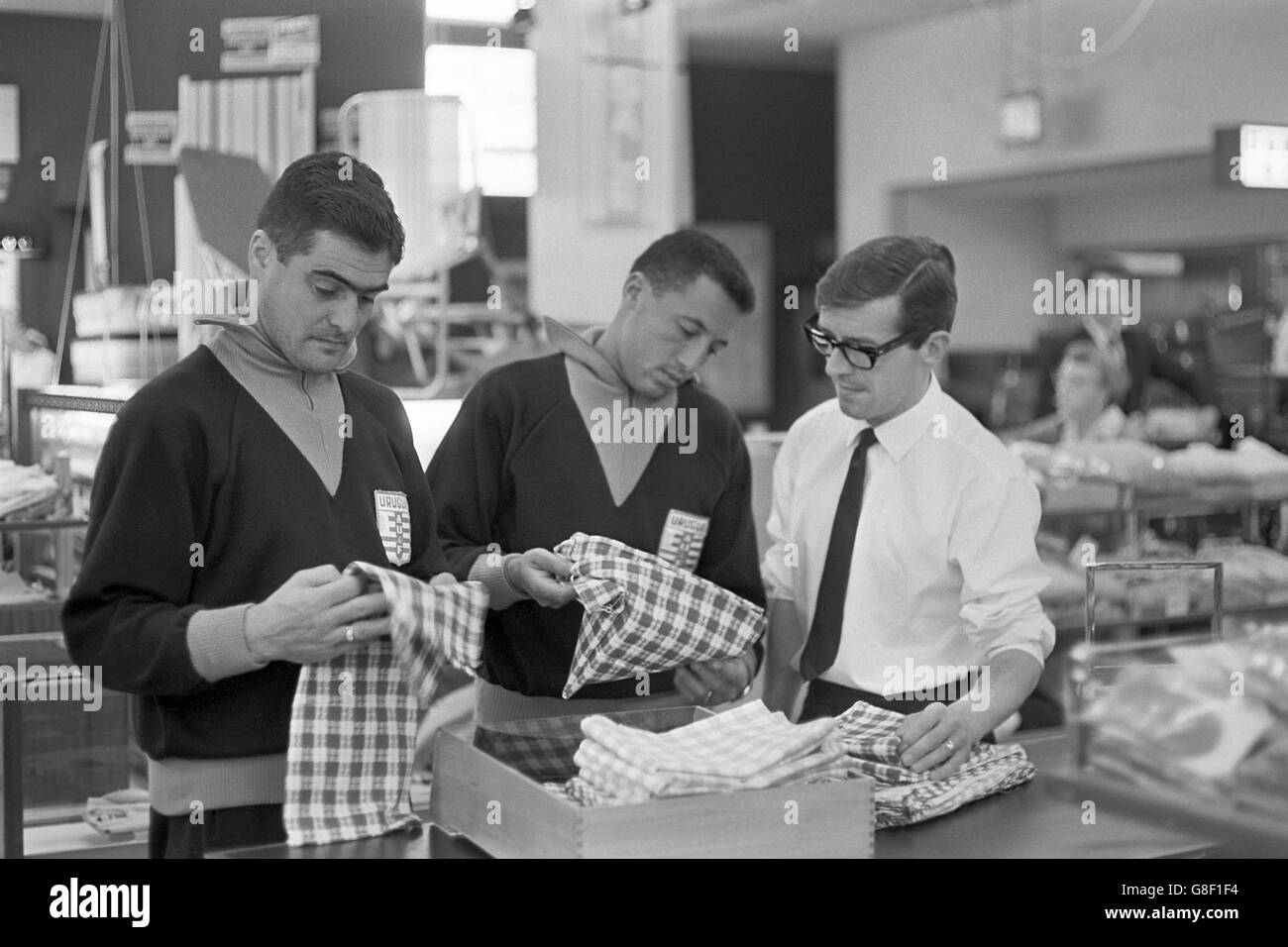 (L-R) Uruguay's Walter Taibo and Julio Cortes examine cuts of cloth during a visit to a local textile factory Stock Photo