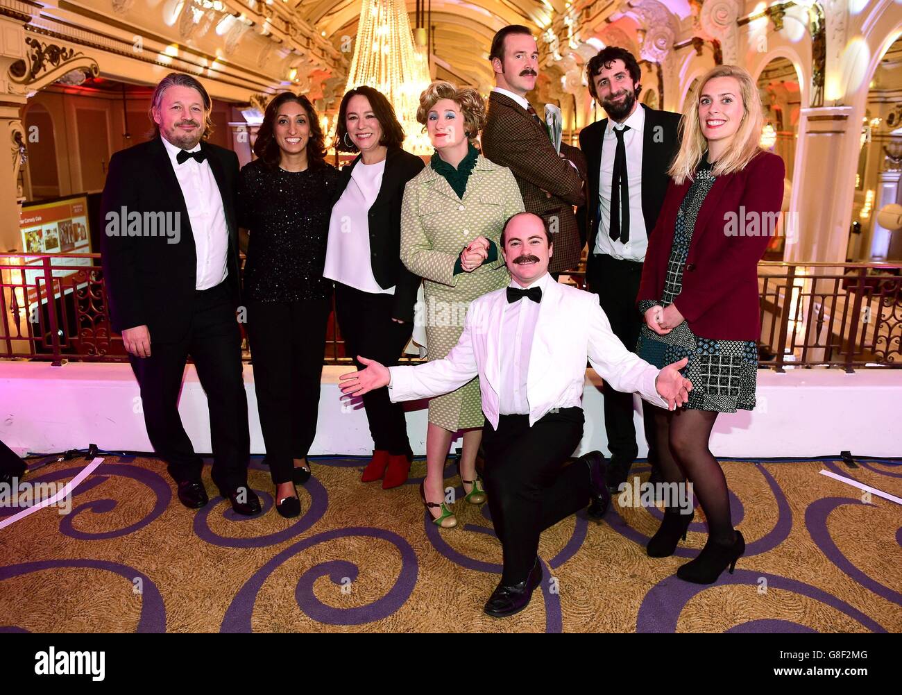 (From left) Richard Herring, Shazia Mirza and Arabella Weir, Mark Watson (second right) and Sara Pascoe (right) are joined by actors playing Sybil and Basil Fawlty and Manuel from Fawlty Towers at the Winter Comedy Gala in aid of ActionAid at the Grand Connaught Rooms in London. Stock Photo