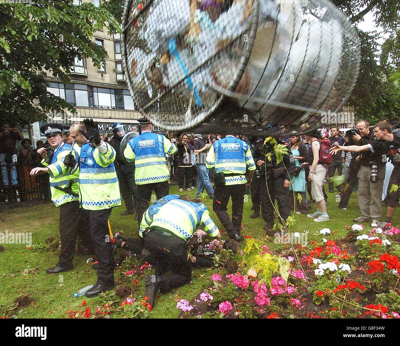 A litter bin hurled by a protester flies through the air towards police in Princes Street, as anti-capitalist demonstrators took to the streets of Scotland's capital ahead of Wednesday's meeting of the G8 leaders in Gleneagles. Stock Photo