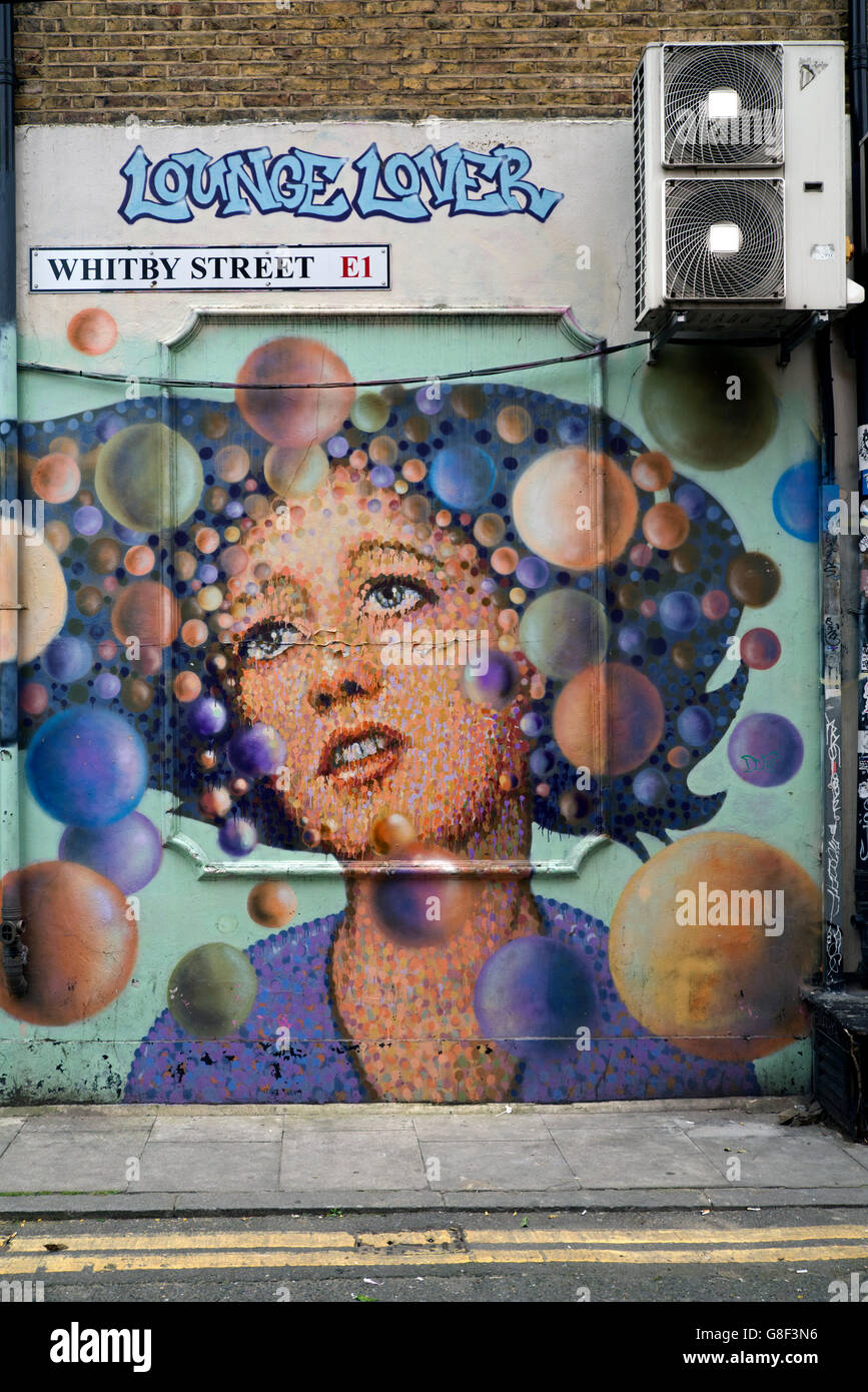 "Lounge Lover" by street artist James Cochran in Whitby Street, Shoreditch, East London, UK. Stock Photo