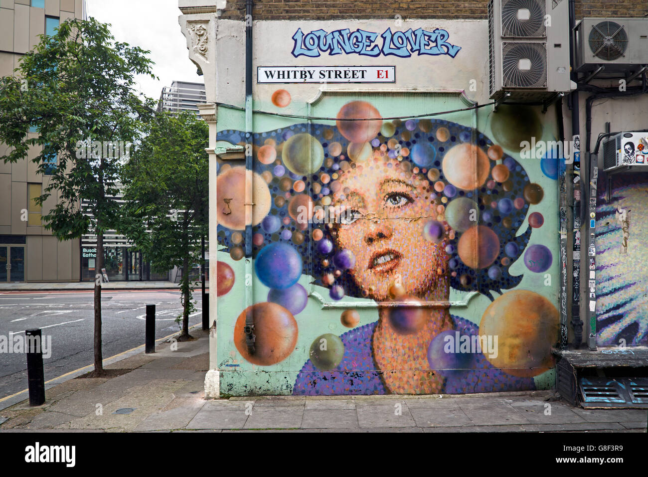 "Lounge Lover" by street artist  James Cochran  in Whitby Street, Shoreditch, East London, UK. Stock Photo