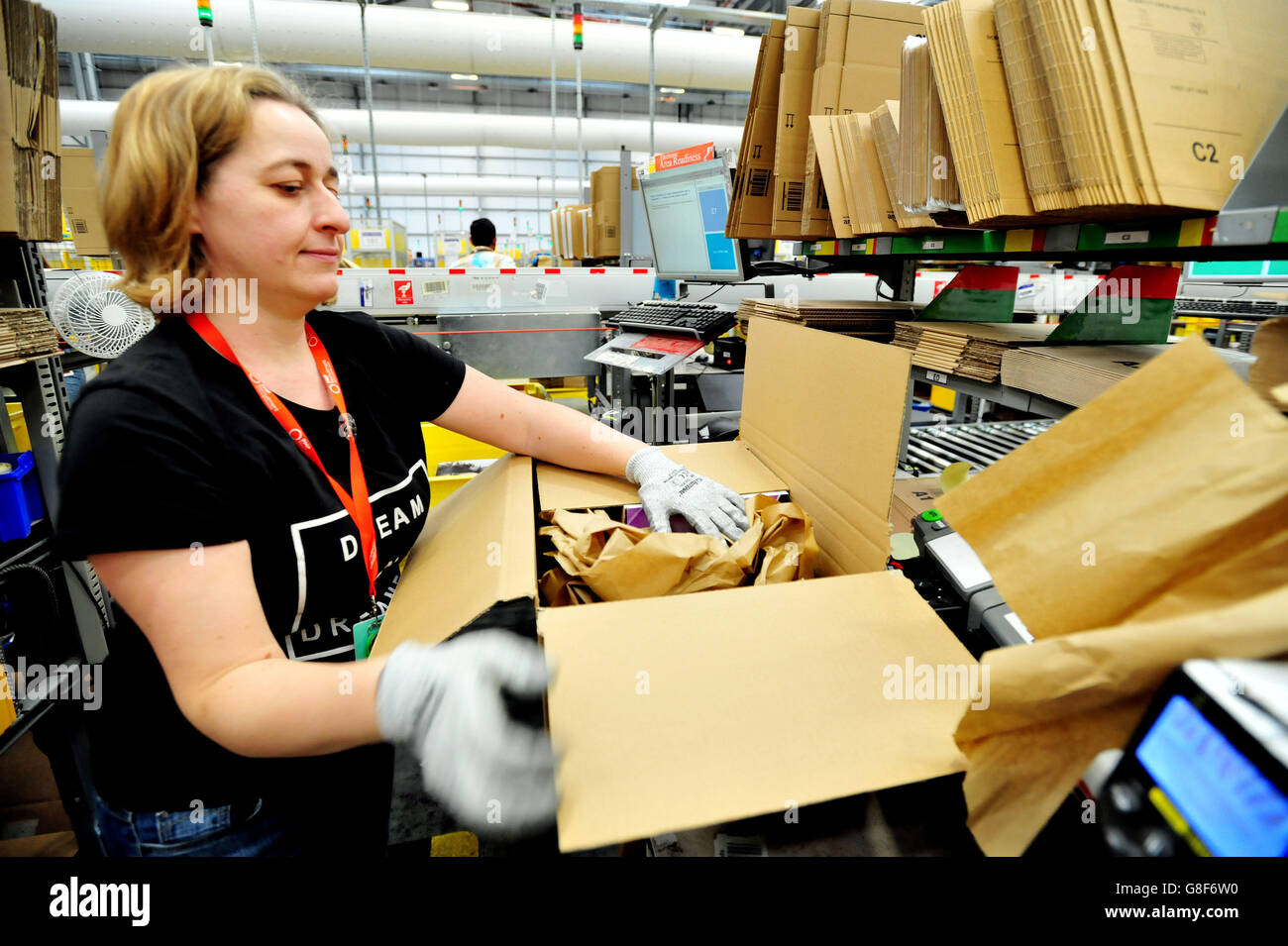 An associate packs customer orders at the Amazon fulfillment centre in