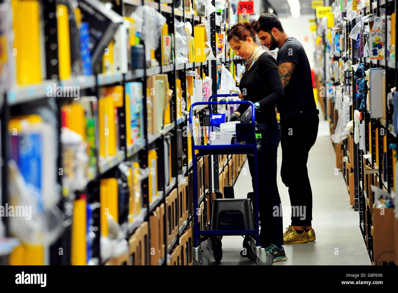 Associates pick up customer orders at the Amazon fulfillment centre in