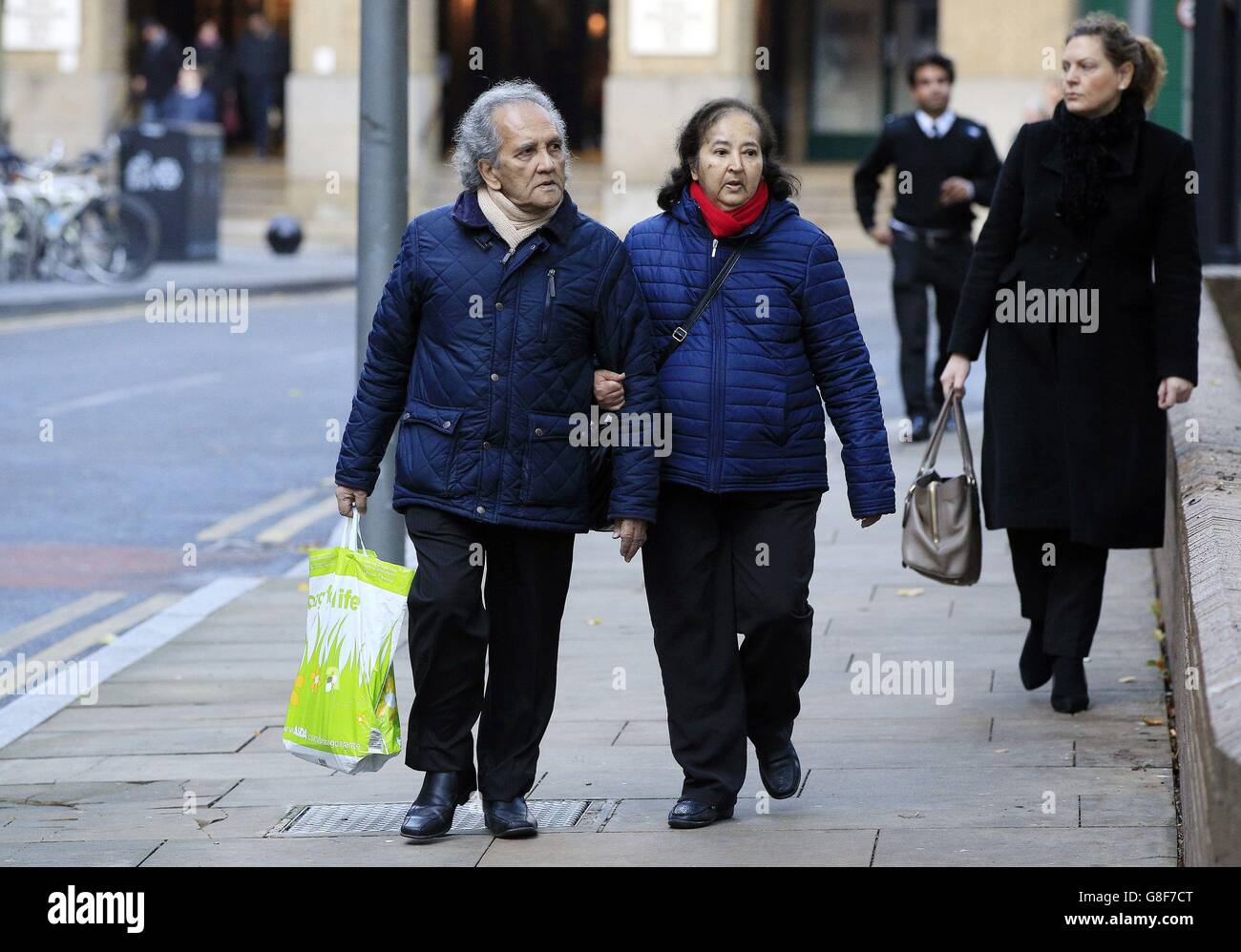 Maoist Aravindan Balakrishnan (left) arrives with an unidentified woman at Southwark Crown Court, London where he denies seven counts of indecent assault and four counts of rape against two women during the 1970s and 1980s. Stock Photo