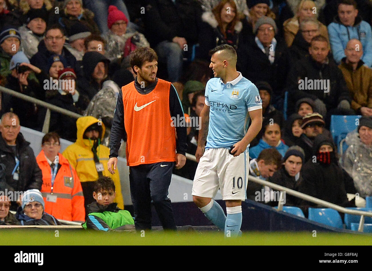 Manchester City's Sergio Aguero speaks with tea-mate David Silva as he leaves the pitch with an injury during the Barclays Premier League match at the Etihad Stadium, Manchester. Stock Photo