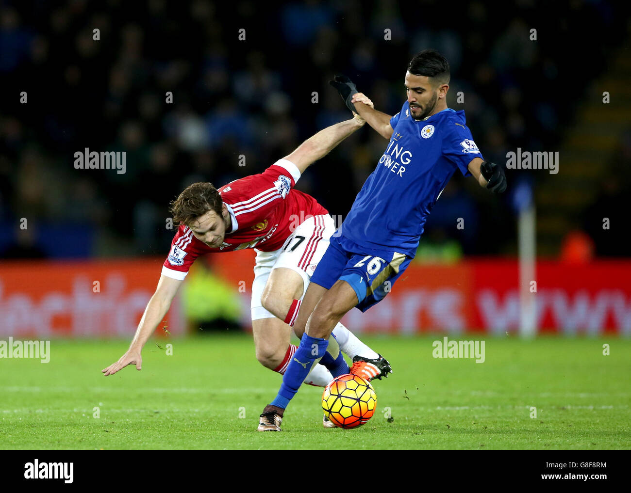 Manchester United's Daley Blind (left) and Leicester City's Riyad Mahrez battle for the ball during the Barclays Premier League match at the King Power Stadium, Leicester. Stock Photo