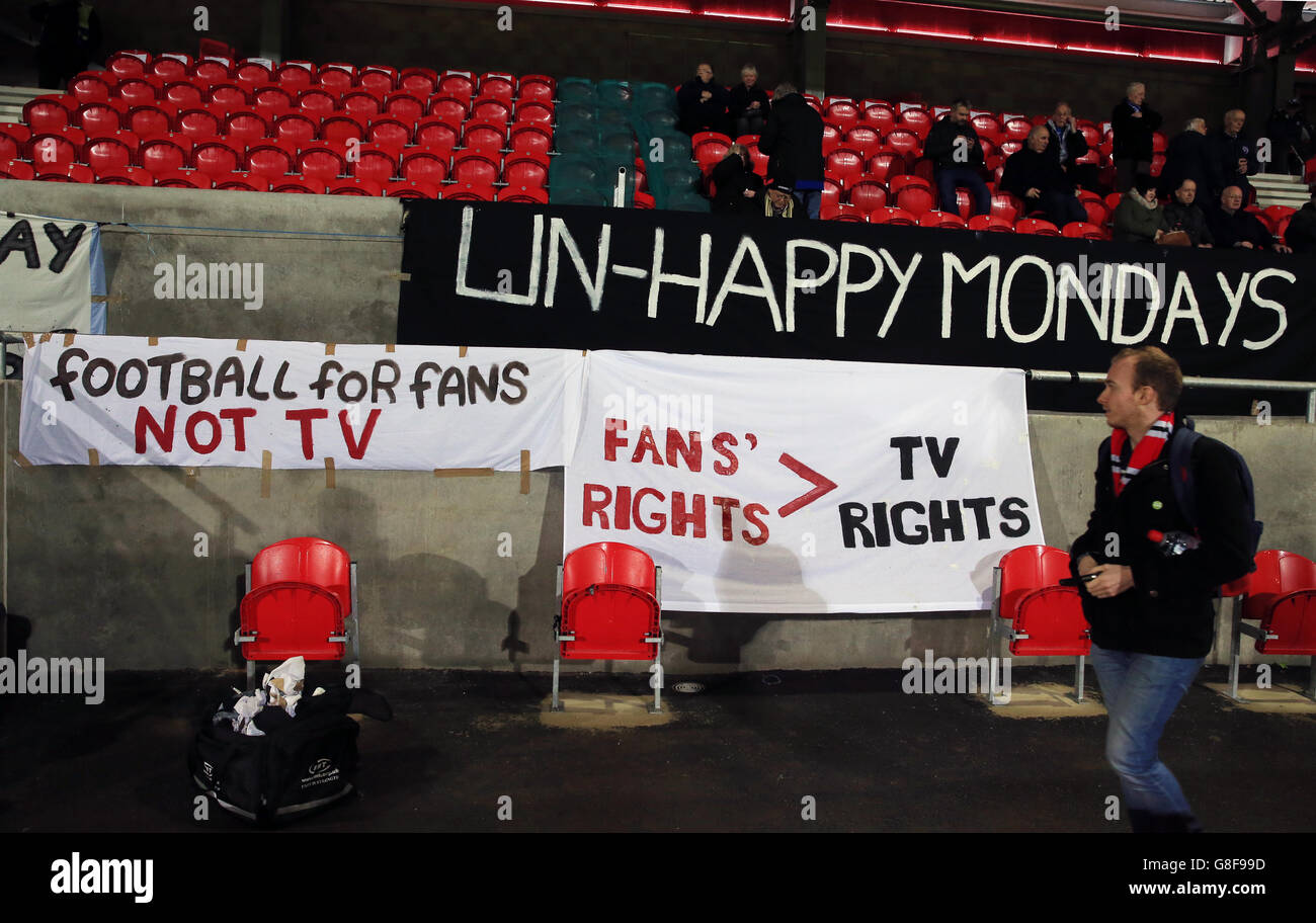 Fans display banners protesting against tonight's match being moved to Monday night for television purposes, before the Emirates FA Cup, First Round match at Broadhurst Park, Manchester. Stock Photo