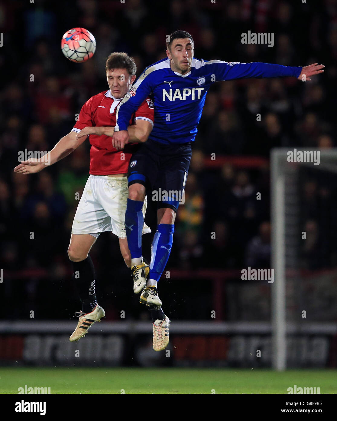 FC United of Manchester's Chris Lynch (left) and Chesterfield's Lee Novak battle for the ball in the air during the Emirates FA Cup, First Round match at Broadhurst Park, Manchester. Stock Photo