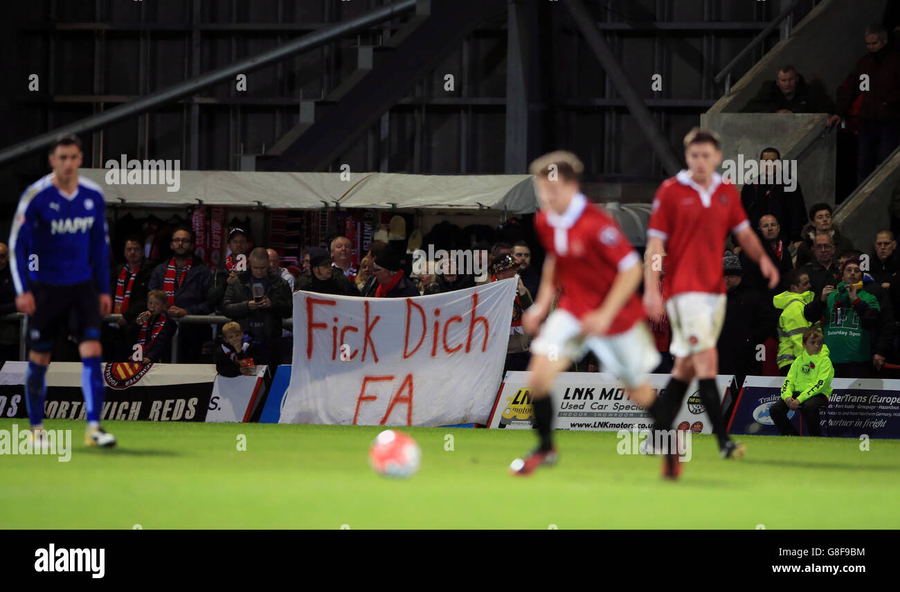 Fans display banners protesting against tonight's match being moved to Monday night for television purposes, during the Emirates FA Cup, First Round match at Broadhurst Park, Manchester. Stock Photo