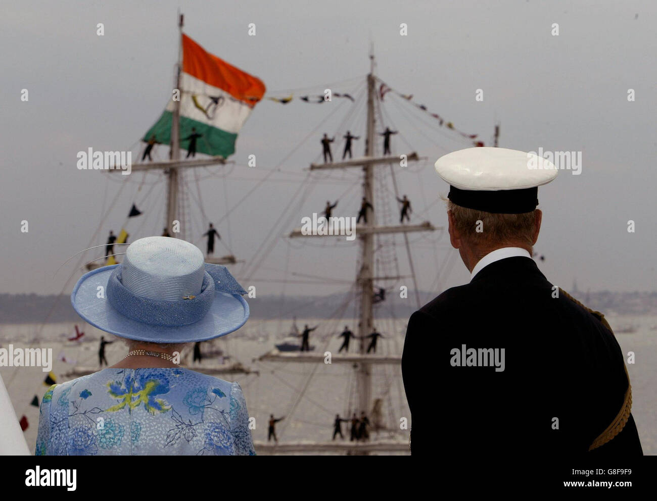 Britain's Queen Elizabeth II and The Duke of Edinburgh watch a tall ship pass, aboard HMS Endurance to review the fleet, Tuesday June 28, 2005. A total of 167 ships from the Royal Navy and 35 nations are taking part in the International Fleet Review at Spithead, off Portsmouth. Stock Photo