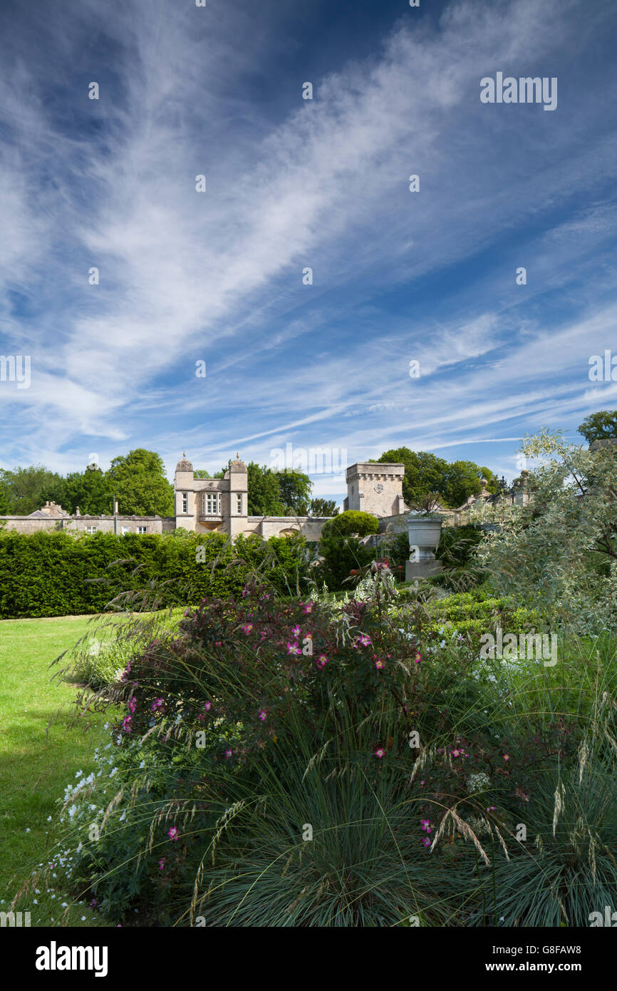 Part of the white space garden of Easton Walled Garden with a glimpse of the Victorian gatehouse by Anthony Salvin beyond, Lincolnshire, England Stock Photo