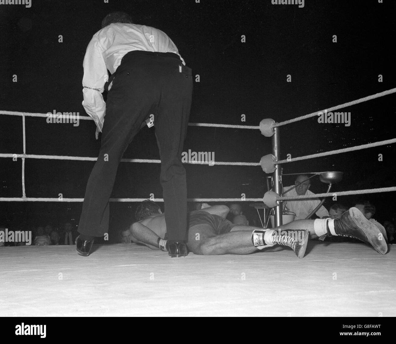 The referee stands over Henry Cooper after he was knocked out in the fourth round by Floyd Patterson. Stock Photo