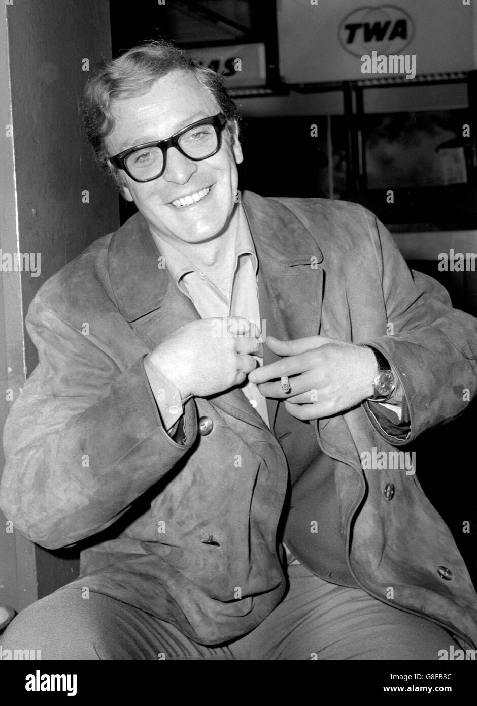 British actor Michael Caine just before leaving London Airport for the USA to collect the 'Star of the Future' award from America's top cinema owners. It will be presented to him at the National Association of Theatre Owners of America's annual convention in New York. Stock Photo