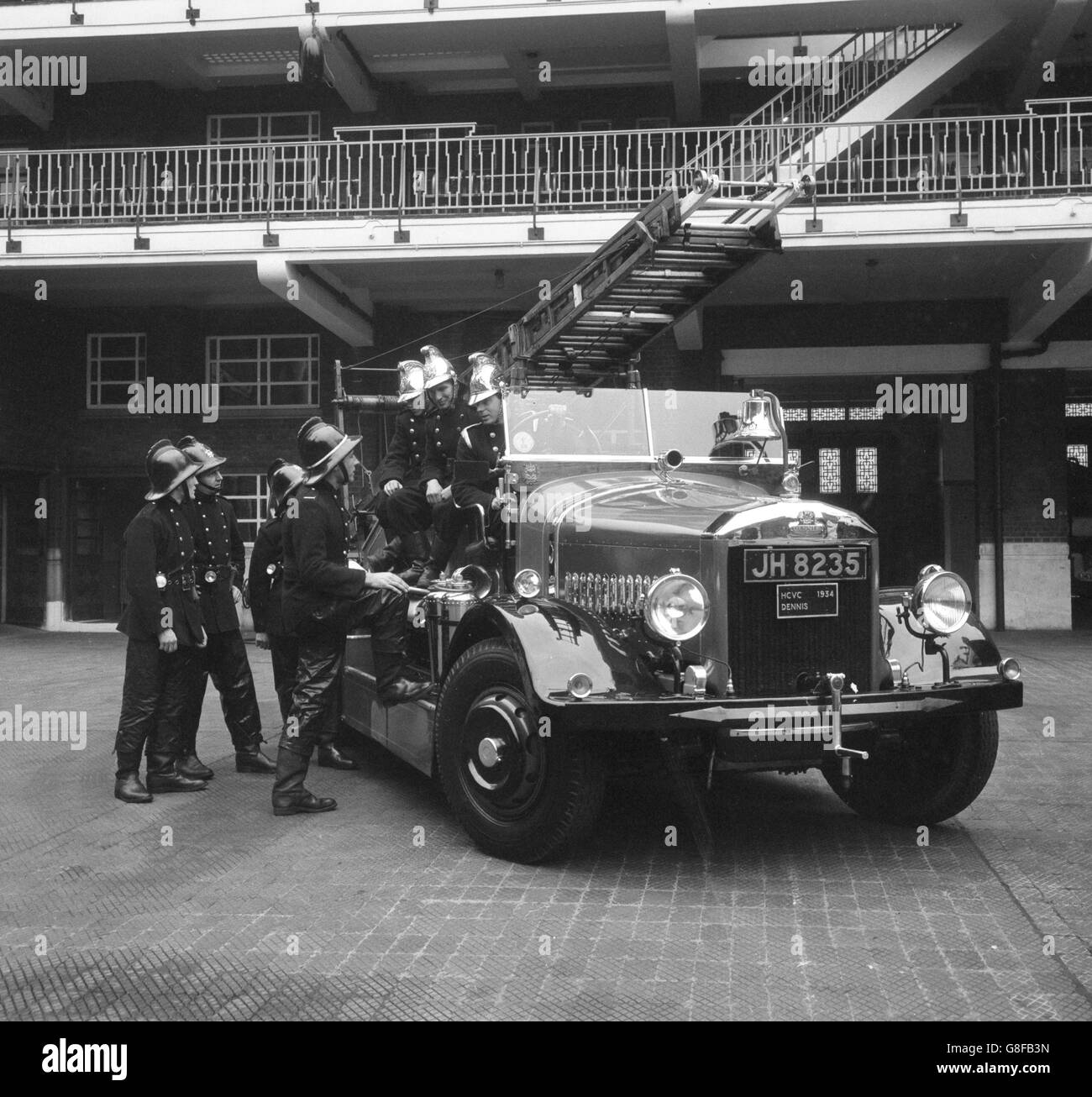 A 1934 vintage fire engine, with owner Paul Adorian at the wheel, leaves London Fire Brigade headquarters on the Albert Embankment at the start of a return trip to paris. He is making the run to celebrate the 300th anniversary of the Great Fire of London and the centenary of the London Fire Brigade's formation. Accompanying Mr Adorian are Ray Stacey and Nigel Howes. Stock Photo