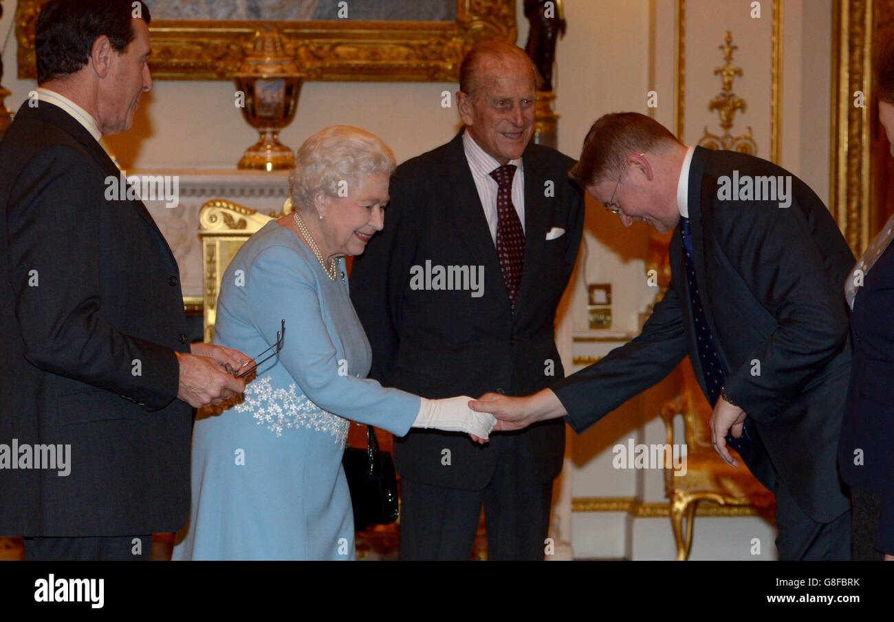 Queen Elizabeth II and the Duke of Edinburgh meet Sir Jeremy Heywood, Cabinet Secretary and Head of the Civil Service, during the annual Civil Service Awards Reception at Buckingham Palace. Stock Photo