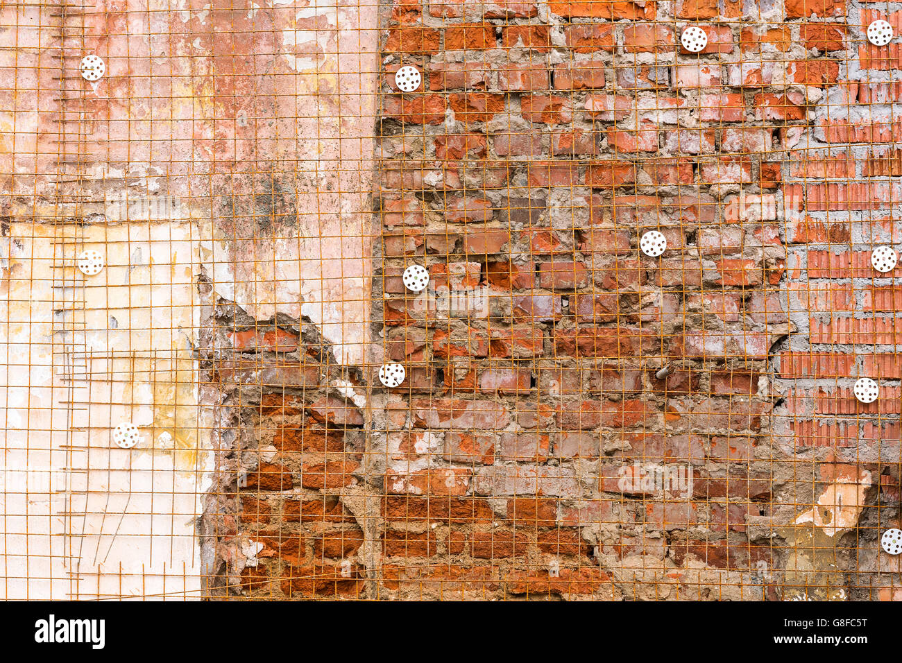 Fragment of old destroyed brick wall with jagged plaster Stock Photo
