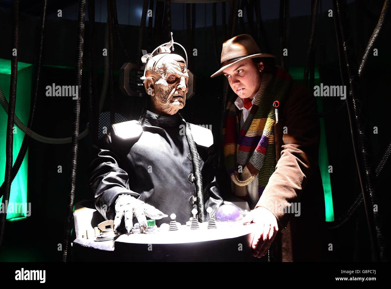 Ben Crampton, dressed as the Tom Baker Doctor Who, looks at a Davros prop at the Doctor Who Festival at the ExCel Centre in London. Stock Photo